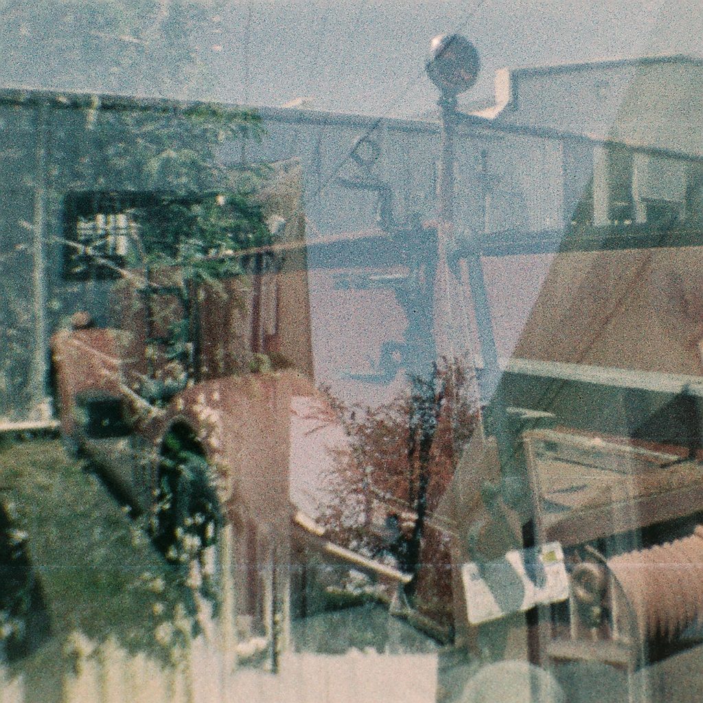 Shop window with reflections, Ferndale, CA. Diana Baby 110.