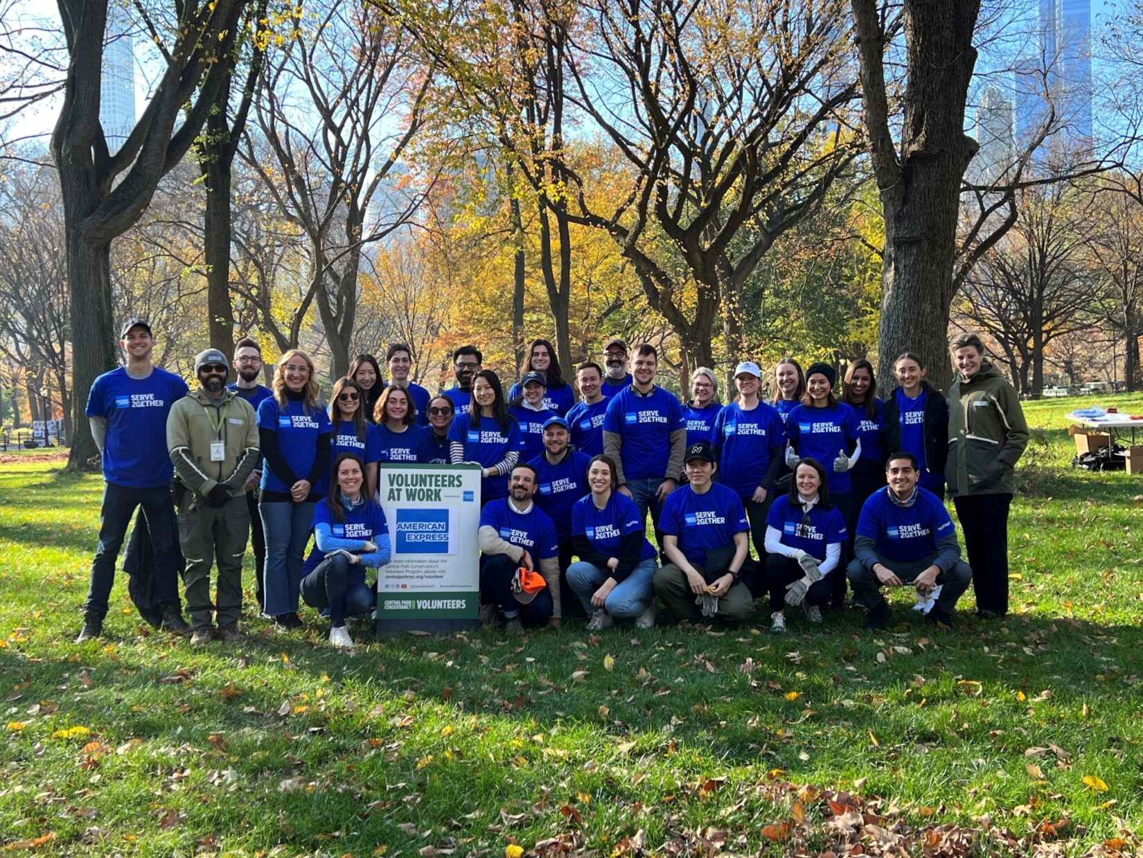 A group of volunteers pose for a photograph in the park