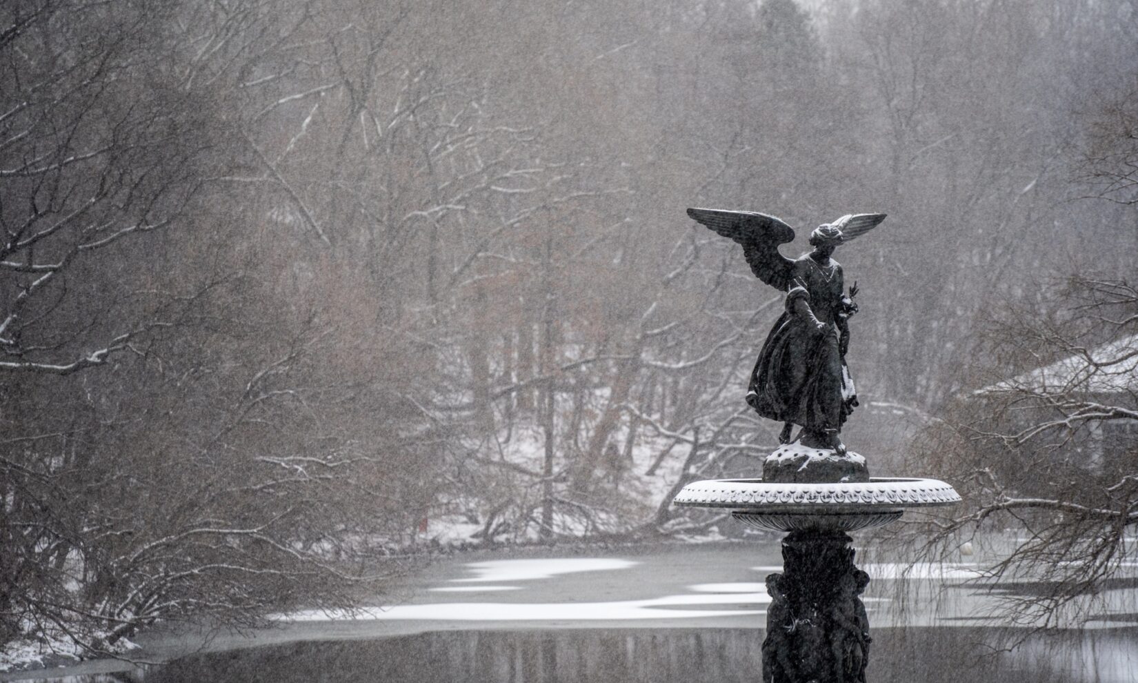 Bethesda Terrace in the snow, in the foreground is the sculpture known as Angel of the Waters