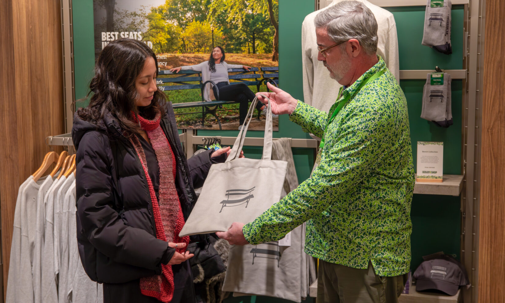 A Conservancy staff member helps a visitor at a gift shop.